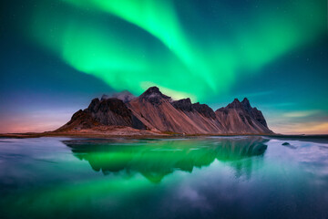 Wall Mural - Famous Stokksnes mountains on Vestrahorn cape in Iceland under incredible sky with Northern lights. Aurora borealis. Polar lights. Landscape photography