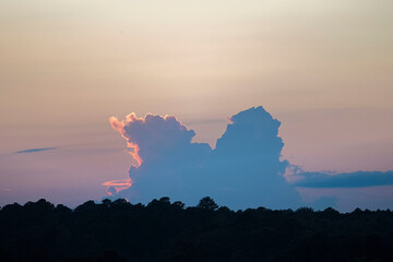 Huge cloud on the horizon at sunset.