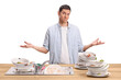 © Ljupco Smokovski - Confused young man with a pile of dirty dishes in a sink