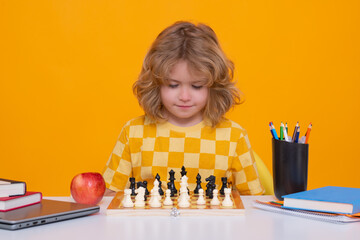 Aufkleber - Kid playing chess. Clever child thinking about chess. Kids early development. Kid with chess on yellow isolated studio background.
