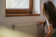 © Valeriia - Adjusting the radiator at home during the heating season