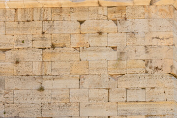 A wall made of stone with a few holes in it, Acropolis in Athens