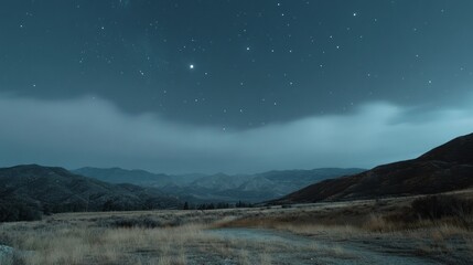 Sticker - A Nighttime View of a Grassy Field with Mountains and a Starry Sky