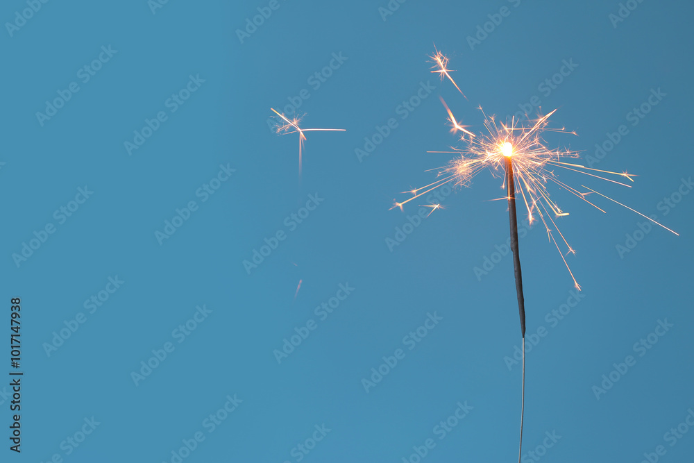 Beautiful Christmas sparkler on blue background
