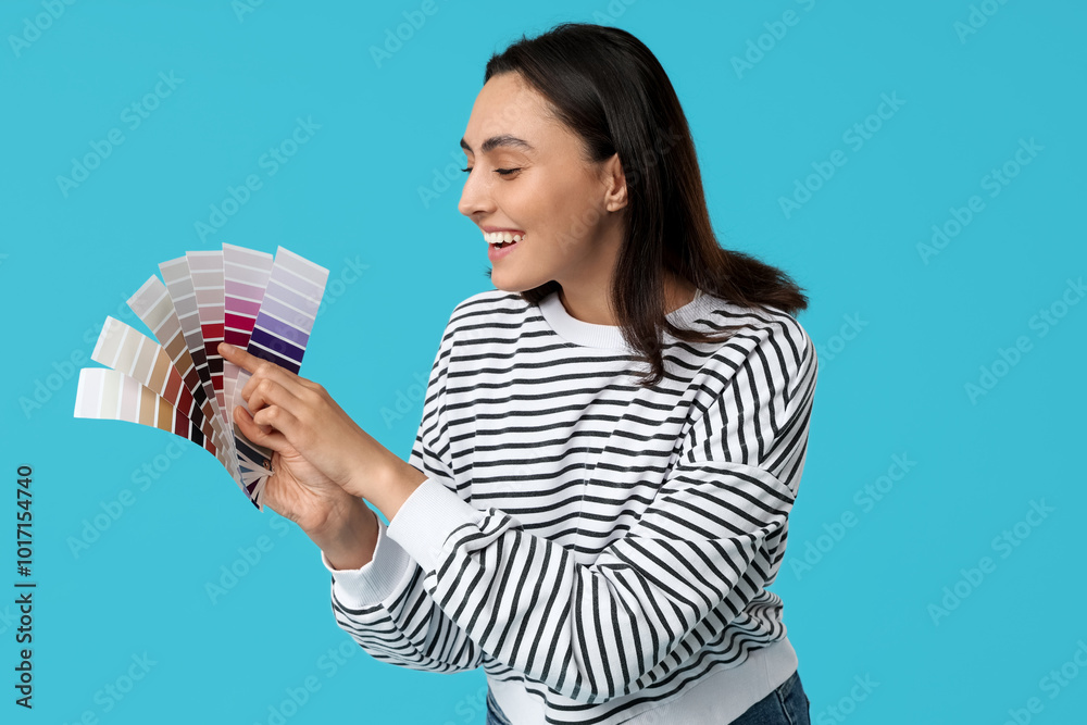 Young woman with color palettes on blue background