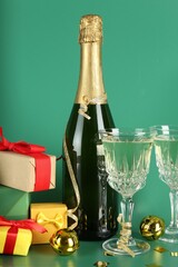 Sticker - Sparkling wine, confetti and other Christmas decor on green background