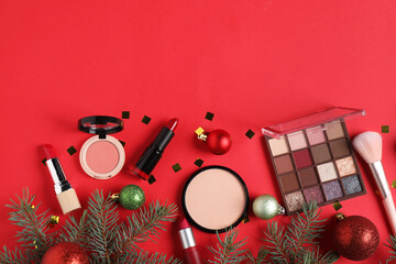 Canvas Print - Flat lay composition with makeup products and Christmas decor on red background, space for text