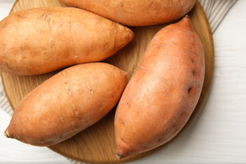 Canvas Print - Fresh raw sweet potatoes on white wooden table, top view