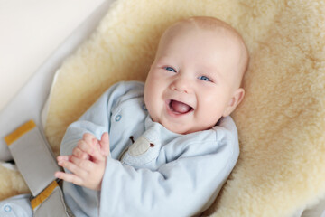 Adorable baby on sheepskin blanket