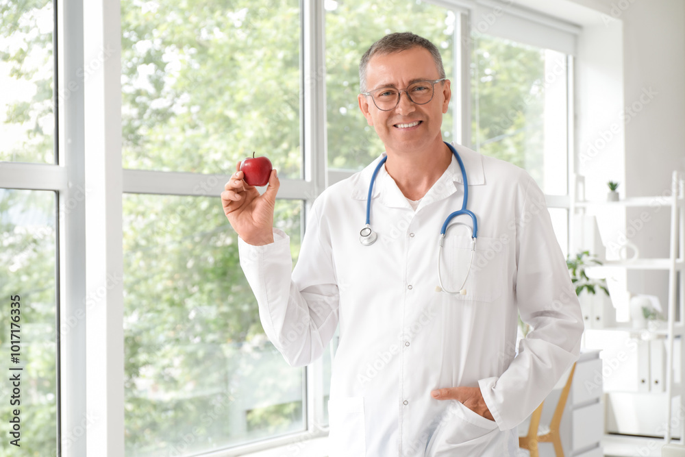 Male doctor with apple in clinic