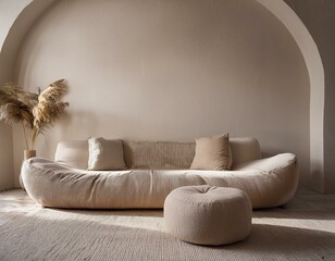 Beige bouclé sofa and pouf against an arched stucco wall. Minimalist interior design of a modern living room, Japanese asian concept