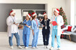 © Pixel-Shot - Group of doctors in Santa hats at hospital on Christmas eve