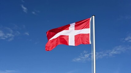 Wall Mural - Slow motion, flag of Denmark fluttering in the wind against a blue sky