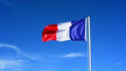 Wall Mural - Slow motion, flag of France fluttering in the wind against a blue sky