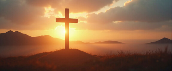 Silhouetted christian cross silhouette on the mountain at sunset