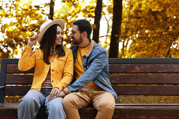 Wall Mural - Beautiful couple spending time together in park on autumn day