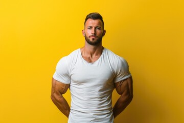 Wall Mural - Muscular man with a calm, determined posture, solid color background ideal for gym promotions that emphasize the connection between strength and focus