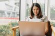 © Sevendeman - Asian woman focus on working her job online, in the public coffee cafe.