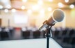 © 为轩 张 - Close-up of a microphone on stage with a blurred background, perfect for conference, meeting, or business town hall event concepts, featuring high-quality details.