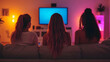 © Siasart - Three friends watching TV in a cozy, colorful living room.