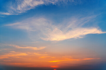 Wall Mural - Cirrus evening clouds backlit by the sun, sky view.