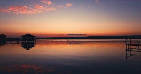 Wall Mural - scenic color sunset over sea shore and small fishing villa house over the water video