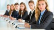 © ChimE - A confident woman dressed in professional attire actively takes notes during an engaging conference meeting in a sleek boardroom.