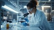 © Tamim - A laboratory technician carefully examining a microscope slide with reagents beside them