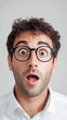 © Synthetica - A man with glasses and a surprised expression on his face. Concept of shock or disbelief