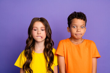 Poster - Photo of charming two little children nervous scared amazed wear trendy orange yellow outfit isolated on violet color background