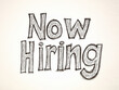 © Jan - Black hand-drawn Now Hiring sign on light background