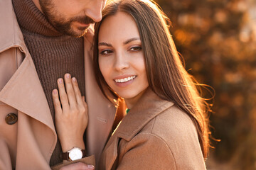 Wall Mural - Beautiful couple hugging in autumn park, closeup