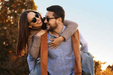 Wall Mural - Beautiful couple having fun together in autumn park