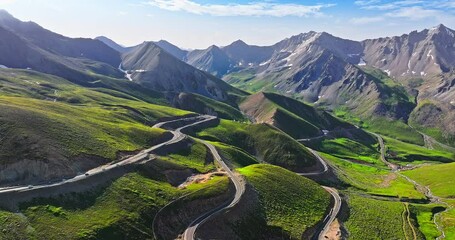 Wall Mural - Winding asphalt highway road in the valley. Spectacular Duku highway and mountain range natural landscape in Xinjiang. Duku highway is the most beautiful highway in China.