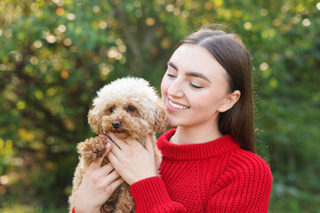 Poster - Portrait of woman with cute dog outdoors