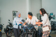 © Odua Images - male and female couple trying out a new motorcycle with saleswoman chatting in the showroom