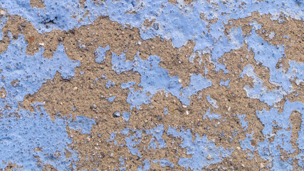 Old wall covered with clay on blue weathered paint