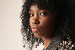 © face_reader_img - Close-up of young dark-skinned pretty woman with afro hairstyle posing indoor. Mindset and mental health.