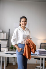 Wall Mural - Businesswoman holding her jacket after working at the office