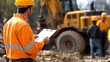 © Keinara Aiko - Construction Worker in Orange Vest and Hard Hat Holding a Clipboard