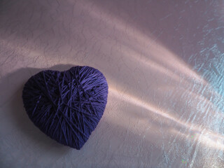 Yarn hearts and reflections on plastic for a minimalist copy space.