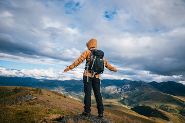 Wall Mural - Woman hiker meditation on the high altitude mountain top grassland