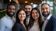 © PhotoHunter - business portrait of four diverse colleagues, close-up on their smiling faces, a mix of ethnicities and genders, two men and two women, warm lighting and professional atmosphere in a modern office
