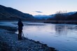 © Victor Bertrand - A photographer captures the serene beauty of a river flowing through a picturesque valley at twilight.