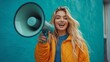 © ifoto - A young woman is holding up her megaphone .The woman appears confident while speaking into the loudspeaker, creating a cheerful atmosphere of advertising or marketing promotion on social media.