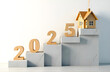 © Olga - Wooden numbers 2025 on the stairs and a private new house on a light background with copy space. Direction of development of the real estate market and private sector in 2025, purchase of a new home