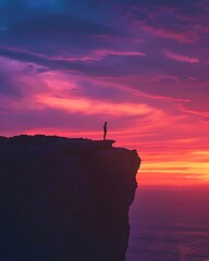 Canvas Print - Silhouetted Figure Standing on Cliff at Sunset with Vibrant Skies