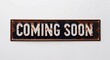 © Erlinda - coming soon lettering on antique rugged rusty metal sign on plain white background