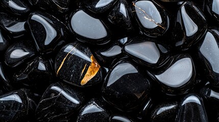   A group of black and white stones arranged in a circle, with a single yellow spot centered on top of each one