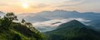 © ParinApril - Sunrise over misty mountains with green hills and soft clouds in the valley.
